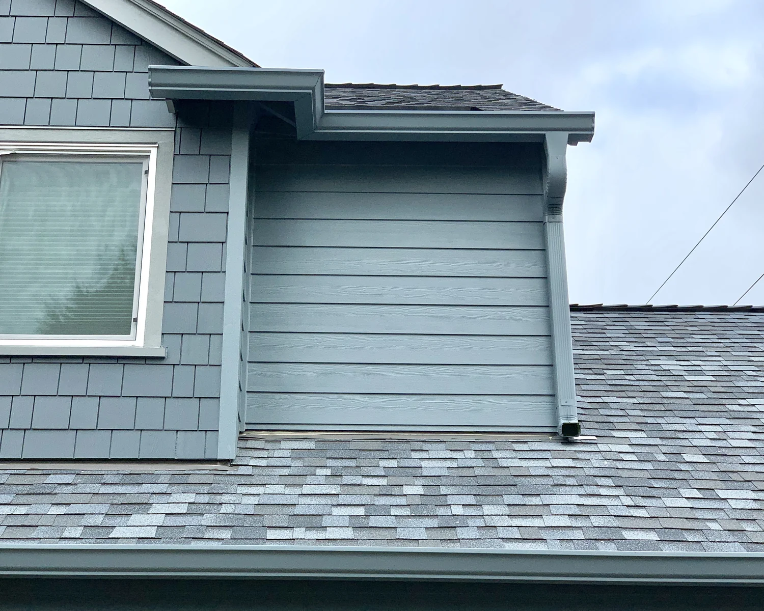 Copper downspout and conductor head with river rock siding in the Boring area